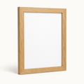 Natural oak 11 by 14 wall picture frame on a light background