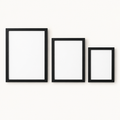 Set of three minimalist black gallery wall picture frames on a light background